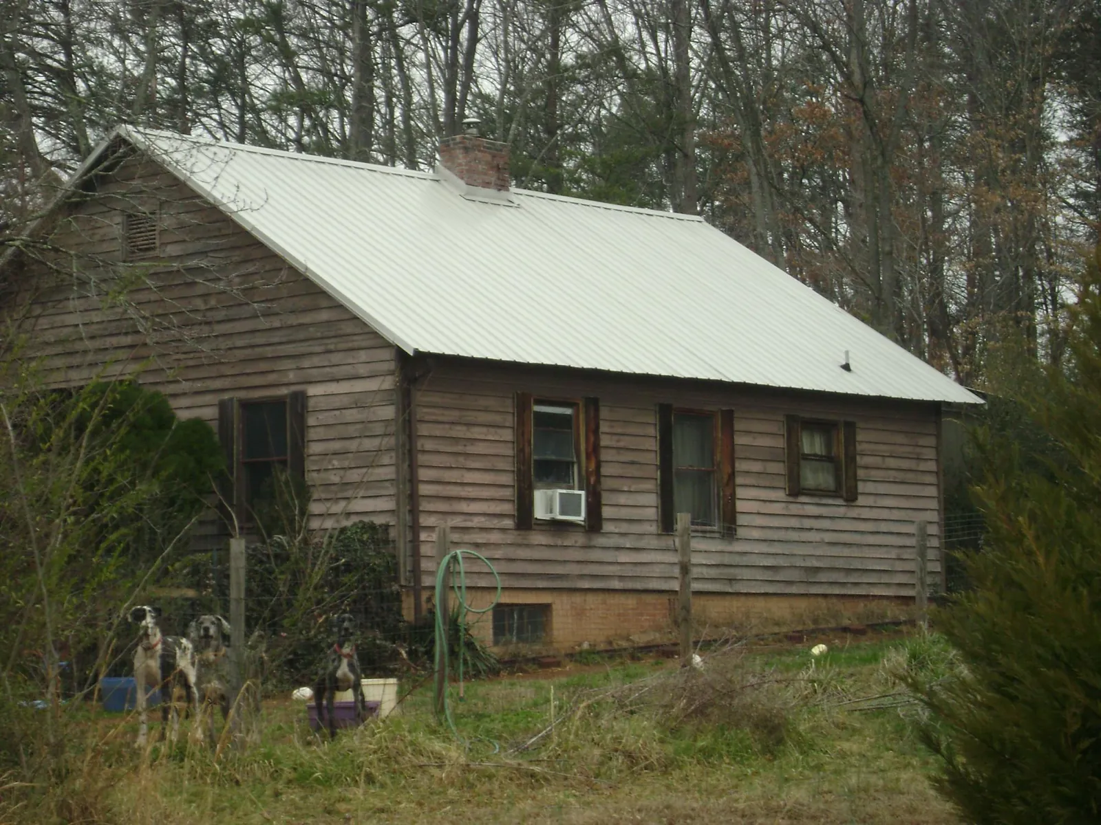 White metal roof on an old wood sided farmhouse, from a Metal Roof Installation job in Vernon